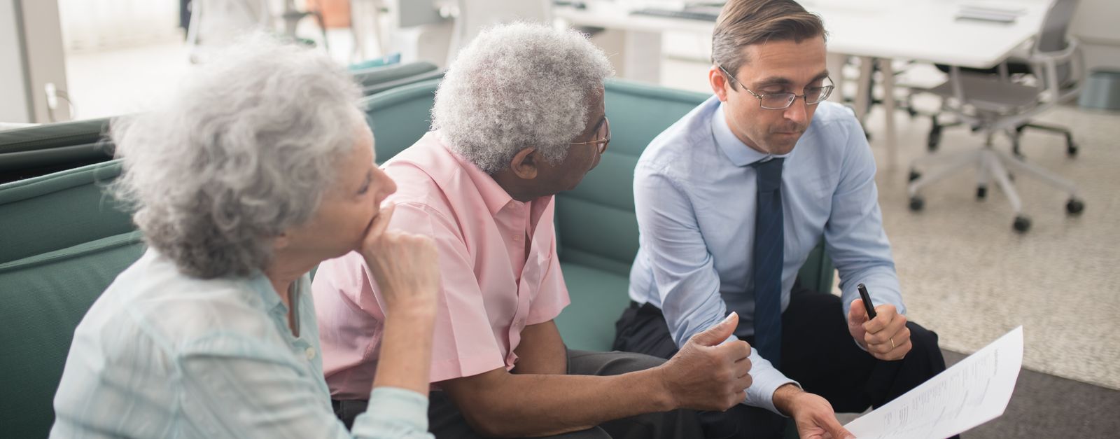 An older Colorado couple comparing Medigap and Medicare Advantage options with an advisor at a table