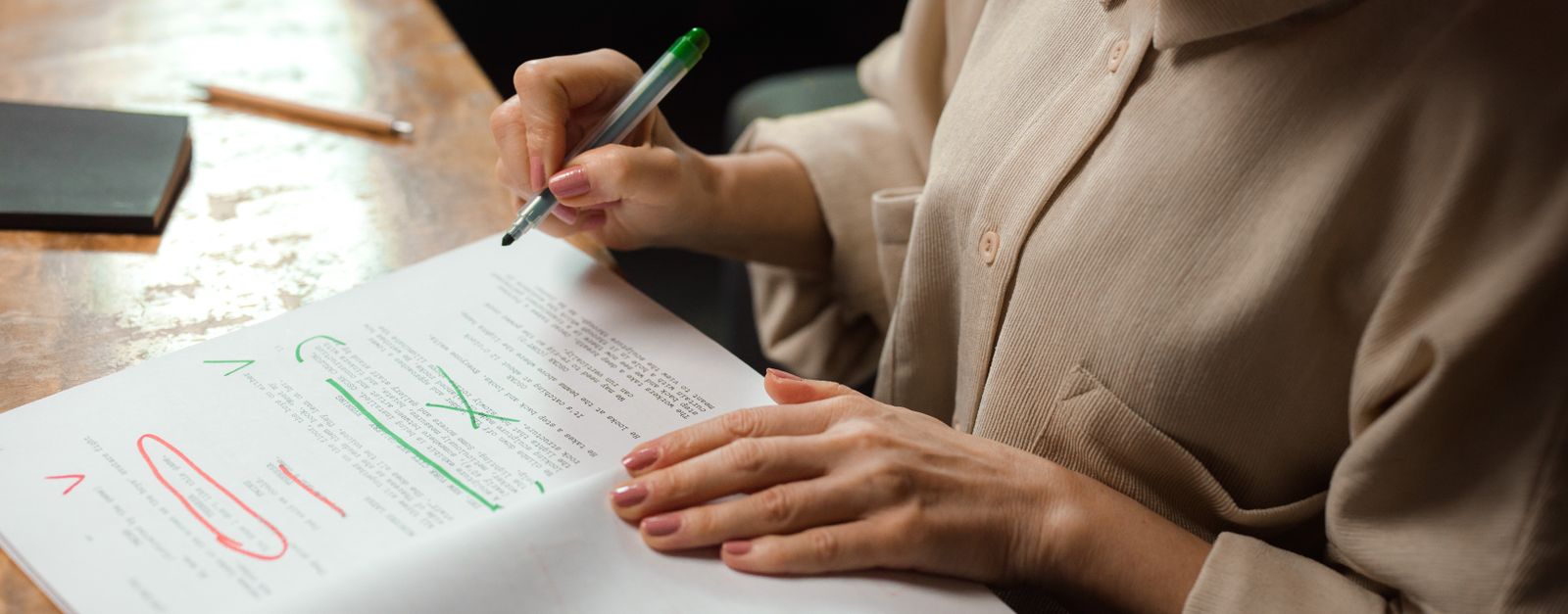 An older Colorado woman reviewing Medicare Supplement paperwork at her kitchen table in Pitkin County